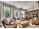 Inviting living room with plush seating, large windows, and a bookcase, perfect for relaxing and enjoying quality time at 251 Copper Leaf Dr., Myrtle Beach, SC 29588
