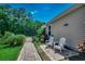 Charming side yard with brick walkway leading to a small garden gate and two Adirondack chairs at 251 Copper Leaf Dr., Myrtle Beach, SC 29588