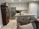Well-lit kitchen with white cabinets, granite countertops, stainless steel refrigerator, and seating at the island at 2529 Suzanne Dr., Conway, SC 29526