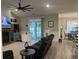 A well lit living room is adjacent to an eat-in kitchen with a stone fireplace and modern ceiling fan at 2529 Suzanne Dr., Conway, SC 29526