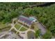 Aerial view of a grand building featuring a pool and ample parking, set amidst lush greenery and a tranquil river at 260 Dunbarton Ln., Conway, SC 29526