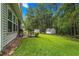 Spacious backyard featuring a well-maintained lawn, a shed, and mature trees providing shade and privacy at 260 Dunbarton Ln., Conway, SC 29526