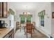 Bright dining room with floral print dining set with lots of light from three large windows at 260 Dunbarton Ln., Conway, SC 29526