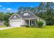 Charming single-story home with a manicured lawn, covered porch, and attached garage, ideal for suburban living at 260 Dunbarton Ln., Conway, SC 29526