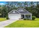 Charming home with a two-car garage, manicured lawn, and inviting front porch offers a welcoming curb appeal at 260 Dunbarton Ln., Conway, SC 29526