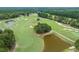 A scenic aerial view of a lush golf course with well-manicured greens, ponds, and mature trees offers a premium recreational experience at 260 Dunbarton Ln., Conway, SC 29526