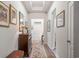 Bright hallway with wood floors, framed artwork, and a decorative table, creating a classic and inviting space at 260 Dunbarton Ln., Conway, SC 29526