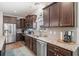 Well-lit kitchen features stainless steel appliances, granite counters, and dark wood cabinetry at 260 Dunbarton Ln., Conway, SC 29526