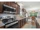 Modern kitchen with stainless steel appliances, granite countertops, and an adjacent dining area at 260 Dunbarton Ln., Conway, SC 29526