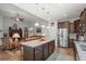 Open-concept kitchen featuring stainless appliances, granite countertops, a central island with seating, and seamless flow to the living area at 260 Dunbarton Ln., Conway, SC 29526