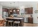 Modern kitchen features stainless steel appliances, granite countertops, dark wood cabinets, and a central island with seating at 260 Dunbarton Ln., Conway, SC 29526