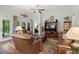 Bright living room with a ceiling fan, hardwood floors, and comfortable seating offers a welcoming and airy ambiance at 260 Dunbarton Ln., Conway, SC 29526