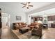 Spacious living room flows into kitchen with hardwood floors, leather furniture, and ample space for relaxation at 260 Dunbarton Ln., Conway, SC 29526