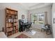 Bright office space with a large window, desk, bookcase, and comfortable seating for a productive work environment at 260 Dunbarton Ln., Conway, SC 29526
