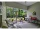 Inviting screened porch with comfortable furniture, perfect for enjoying the outdoors while protected from insects at 260 Dunbarton Ln., Conway, SC 29526
