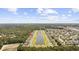 An expansive aerial view showcases a lakefront residential neighborhood with a mix of natural landscapes at 284 Whipple Run, Myrtle Beach, SC 29588