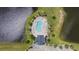 An aerial view captures a community pool, surrounded by landscaping and residential homes near a pond at 284 Whipple Run, Myrtle Beach, SC 29588