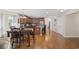 Open kitchen and dining area featuring hardwood floors, a central island, and modern lighting at 284 Whipple Run, Myrtle Beach, SC 29588