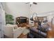 Cozy living room with hardwood floors, a ceiling fan, and an open layout to the kitchen at 284 Whipple Run, Myrtle Beach, SC 29588