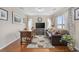 Cozy living room with a leather sofa, area rug, and a large TV at 284 Whipple Run, Myrtle Beach, SC 29588