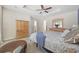 Carpeted main bedroom offers a tray ceiling with fan, sitting area, and wood furniture at 284 Whipple Run, Myrtle Beach, SC 29588