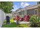 An inviting patio with red Adirondack chairs and a cozy fire pit perfect for relaxing evenings outdoors at 284 Whipple Run, Myrtle Beach, SC 29588