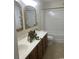 Bathroom with dual sinks, decorative mirrors, and a combination tub/shower at 3017 Mercer Dr. # 0, Conway, SC 29526