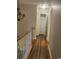 Hallway with chandelier lighting, wooden floors, a closet, and neutral wall paint at 3017 Mercer Dr. # 0, Conway, SC 29526