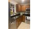 This kitchen features wood cabinets, stainless steel appliances, and a black granite countertop at 3017 Mercer Dr. # 0, Conway, SC 29526