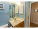 Well-lit bathroom featuring a vanity with storage and framed mirror at 305 N Hillside Dr. # 206, North Myrtle Beach, SC 29582