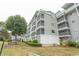 Multi-story building with screened-in patios and well-maintained lawn at 305 N Hillside Dr. # 206, North Myrtle Beach, SC 29582