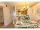 Cozy dining area with a glass table and seating for four, adjacent to a charming kitchen at 305 N Hillside Dr. # 206, North Myrtle Beach, SC 29582