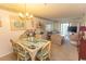 Dining room with rattan table set, wicker chairs and view to living area at 305 N Hillside Dr. # 206, North Myrtle Beach, SC 29582