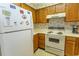 Kitchen with laminate countertops, stainless sink, wooden cabinets and floral wallpaper at 305 N Hillside Dr. # 206, North Myrtle Beach, SC 29582