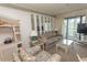 Relaxing living room featuring a plush sofa, decorative mirrors, and access to a private balcony at 305 N Hillside Dr. # 206, North Myrtle Beach, SC 29582
