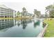 Scenic pond view with fountain and condominium buildings in the background under a cloudy sky at 305 N Hillside Dr. # 206, North Myrtle Beach, SC 29582