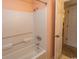 Shower tub combo featuring white tile and peach walls at 305 N Hillside Dr. # 206, North Myrtle Beach, SC 29582
