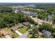 Aerial view of a house near commercial properties, in a quiet neighborhood with mature trees at 4 Clemson Rd., Conway, SC 29526