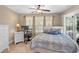 Bright bedroom with ceiling fan, large windows, desk and private access to screened porch at 4 Clemson Rd., Conway, SC 29526
