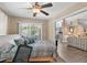 Cozy bedroom with a ceiling fan, slider access to porch, and a glimpse into the living room at 4 Clemson Rd., Conway, SC 29526