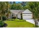 Charming single-story home with a brick and siding exterior, lush landscaping, and attached garage at 4 Clemson Rd., Conway, SC 29526