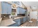 Bright kitchen featuring blue cabinets, stainless appliances, mosaic backsplash and lots of natural light at 4 Clemson Rd., Conway, SC 29526
