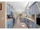 Open kitchen featuring blue cabinets, stainless appliances, and a view to the back patio at 4 Clemson Rd., Conway, SC 29526