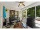 Relaxing enclosed porch with table and chairs, ceiling fan, and access to outdoor areas at 4 Clemson Rd., Conway, SC 29526