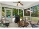 Enclosed porch featuring outdoor seating, fan, and views of the private backyard at 4 Clemson Rd., Conway, SC 29526