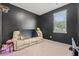 Fun bedroom with dark walls, a window, and a comfy couch, ideal for relaxation at 402 Toledo St., Conway, SC 29526