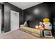 Cozy bedroom with a comfortable couch, dark walls, and a window, perfect for a relaxing getaway at 402 Toledo St., Conway, SC 29526