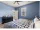 Bright bedroom features a door to the backyard, ceiling fan, and a black dresser at 402 Toledo St., Conway, SC 29526