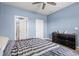 Stylish bedroom featuring a ceiling fan, dresser, and an ensuite bathroom with a glass door at 402 Toledo St., Conway, SC 29526