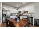 Bright kitchen featuring granite countertops, stainless steel appliances, and wooden dining table with seating at 402 Toledo St., Conway, SC 29526